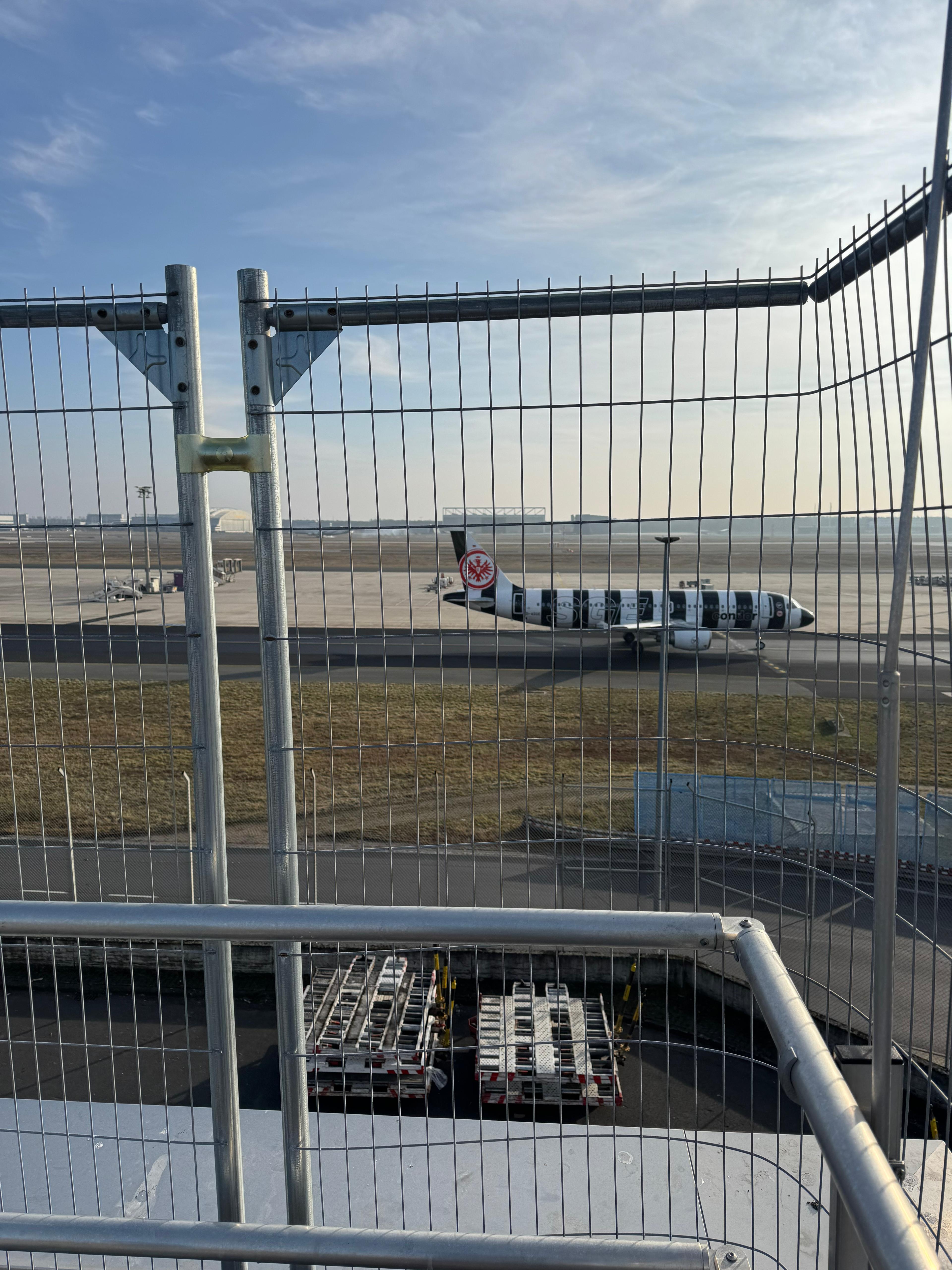 Bauzaun mit Kran Fraport Frankfurt Blick auf Rollfeld